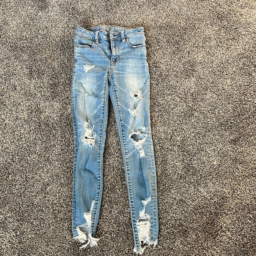 High rise American Eagle jegging with holes, lighter color. size 0 regular.